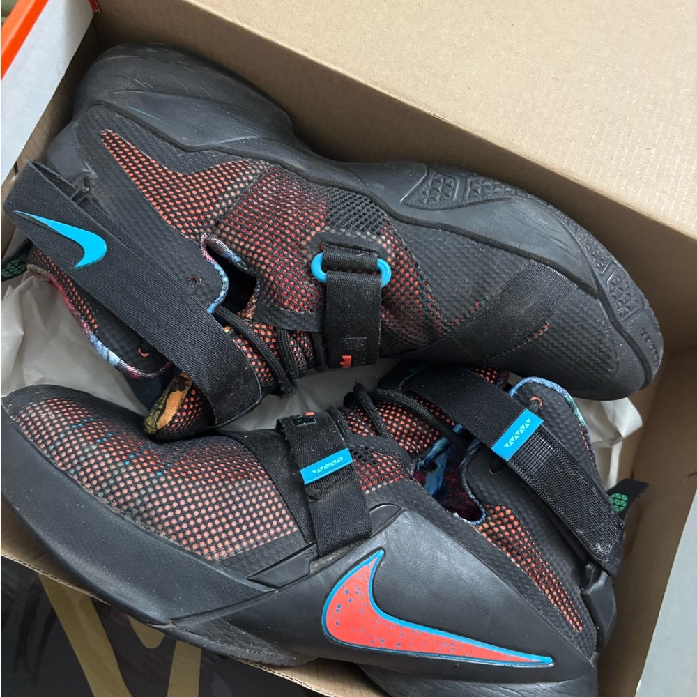Nike Kids Black and Orange Sneakers with Blue Accents